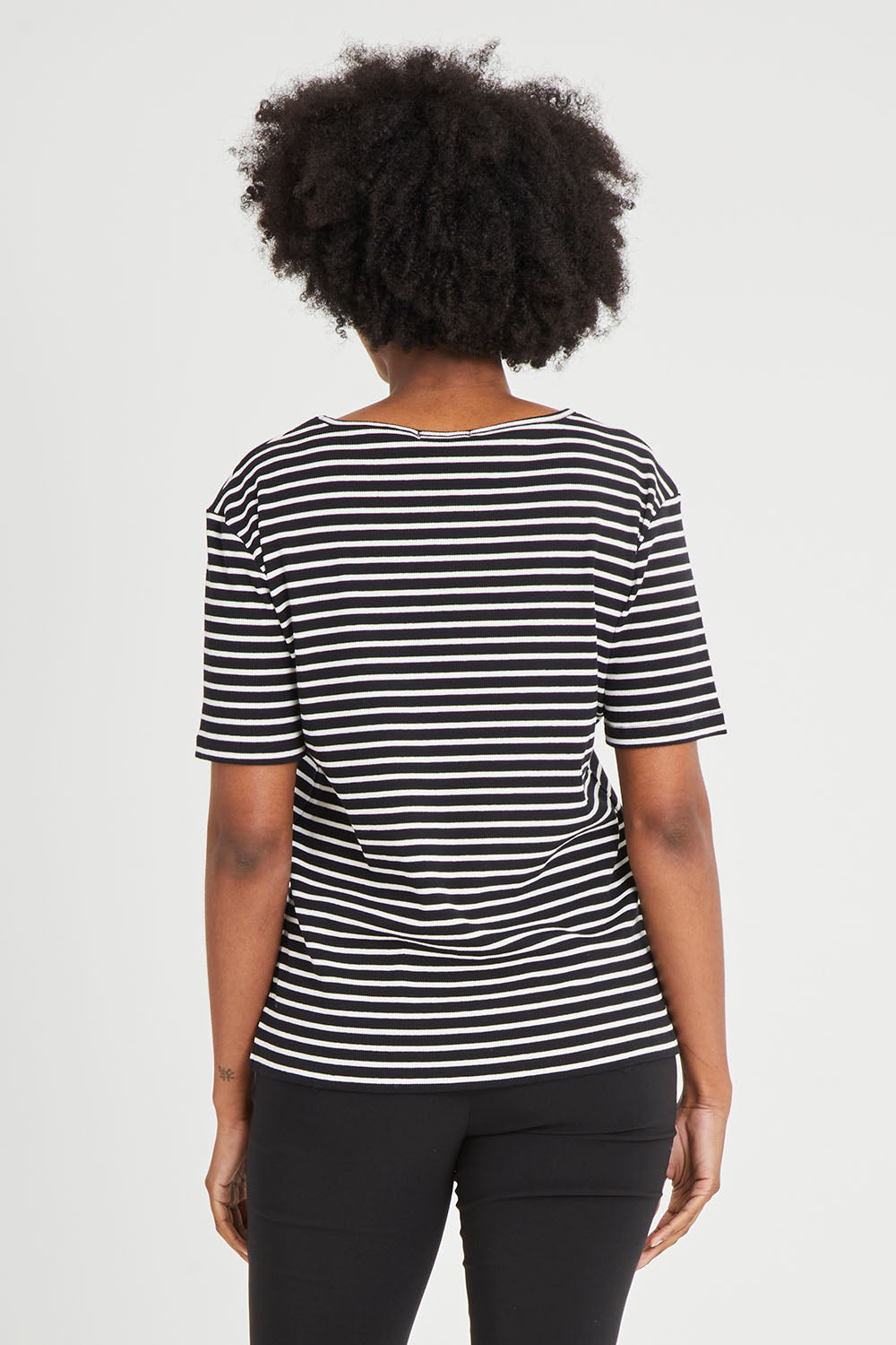 Model Aiyana wearing size 10 of The Keepers V Neck Striped Rib Tee in colour Black (Black), from the back