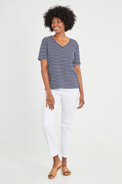 Model Aiyana wearing size 10 of The Keepers V Neck Striped Rib Tee in colour Navy (Blue), from the front, showing the whole outfit