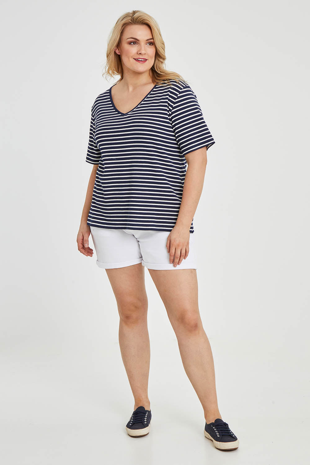 Model Keeara wearing size 16 of The Keepers V Neck Striped Rib Tee in colour Navy (Blue), from the front, showing the whole outfit