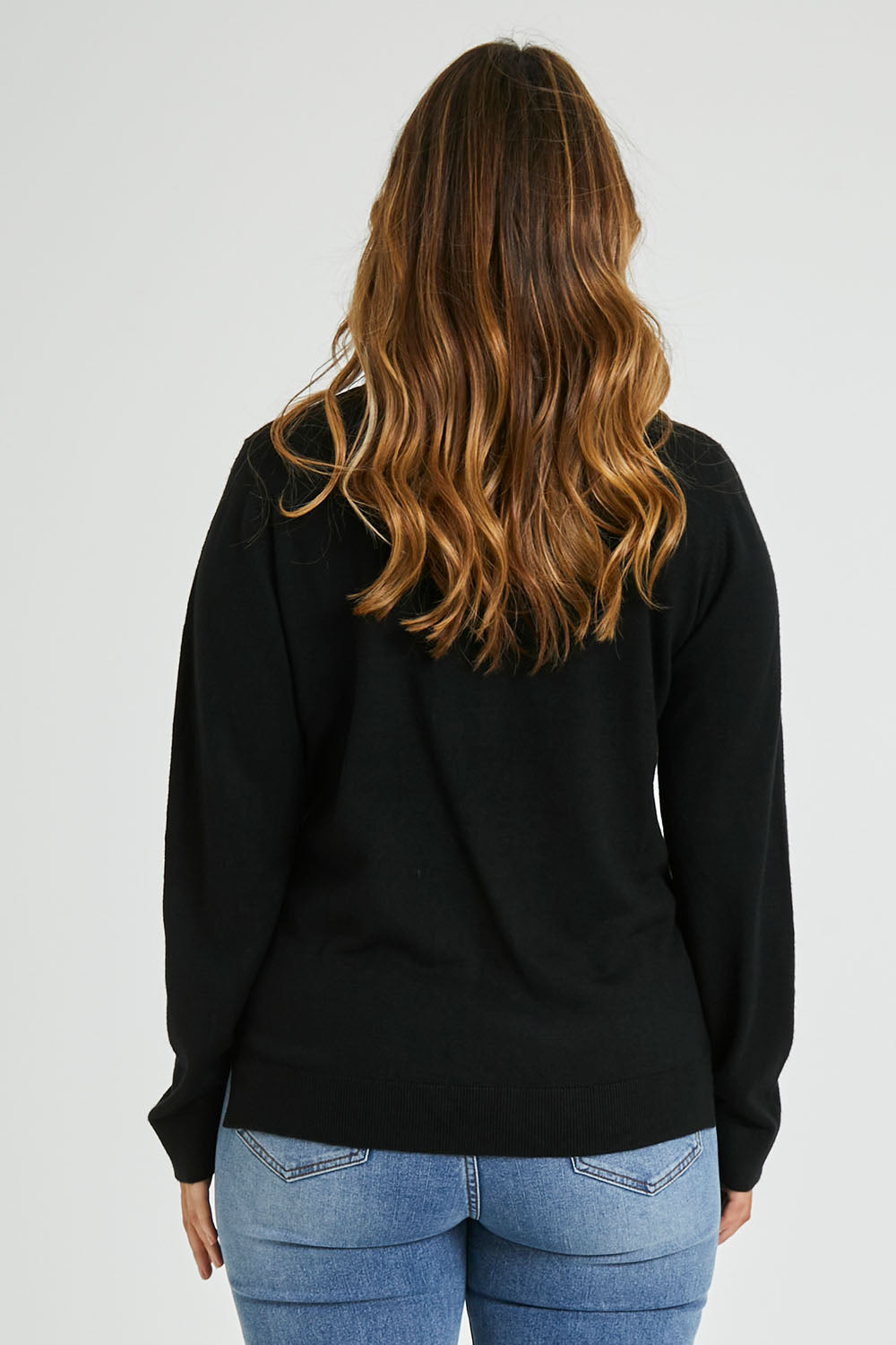 Model Laura wearing size L of The Keepers Soft V Neck Jumper in colour Black (Black), from the back