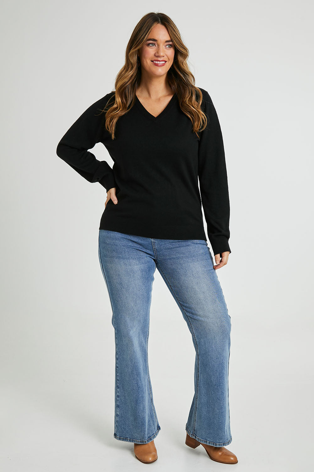 Model Laura wearing size L of The Keepers Soft V Neck Jumper in colour Black (Black), from the front, showing the whole outfit