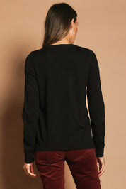 Model Madeline wearing size S of The Keepers Soft V Neck Jumper in colour Black (Black), from the back