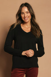 Model Madeline wearing size S of The Keepers Soft V Neck Jumper in colour Black (Black), from the front, showing the whole outfit