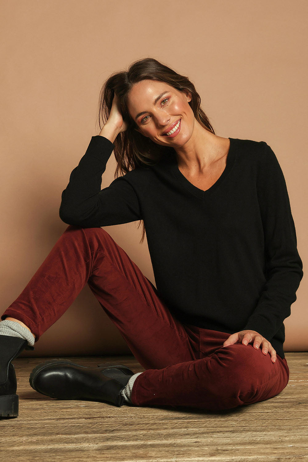 Model Madeline wearing size S of The Keepers Soft V Neck Jumper in colour Black (Black), from the front, showing the whole outfit