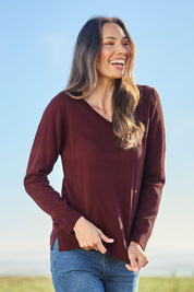 Model Amanda wearing size S of The Keepers Soft V Neck Jumper in colour Burgundy (Purple), from the front, showing the whole outfit