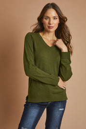 Model Madeline wearing size S of The Keepers Soft V Neck Jumper in colour Darkolive (Green), from the front, showing the whole outfit