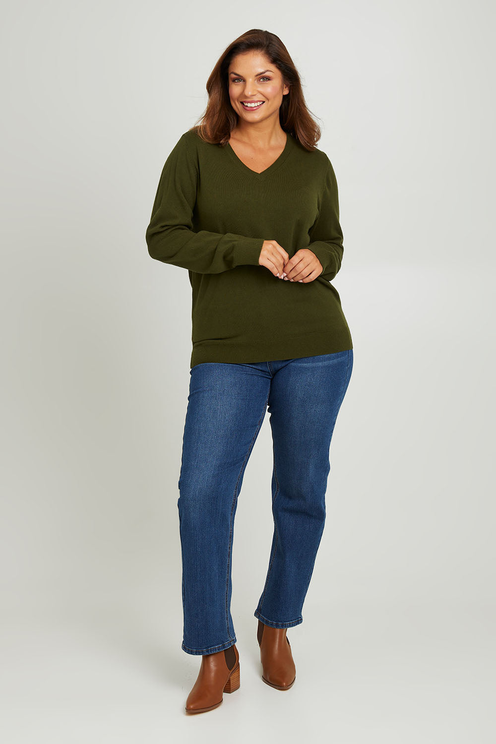 Model Monique wearing size L of The Keepers Soft V Neck Jumper in colour Darkolive (Green), from the front, showing the whole outfit