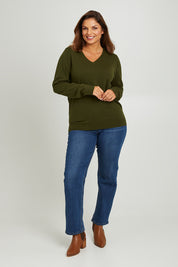 Model Monique wearing size L of The Keepers Soft V Neck Jumper in colour Darkolive (Green), from the front, showing the whole outfit