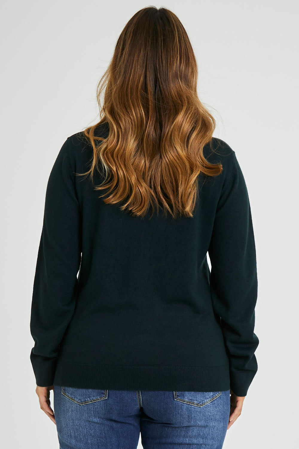 Model Laura wearing size L of The Keepers Soft V Neck Jumper in colour Darkpetrol (Blue), from the back