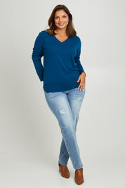 Model Monique wearing size L of The Keepers Soft V Neck Jumper in colour Petrol (Blue), from the front, showing the whole outfit