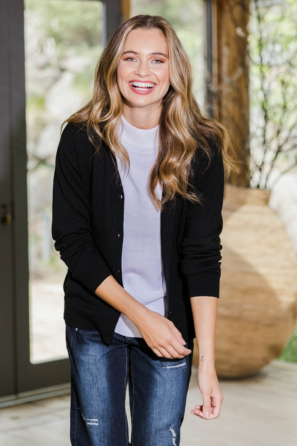 Model Tahlia wearing size S of The Keepers Soft Button Up Cardigan in colour Black (Black), from the front, showing the whole outfit