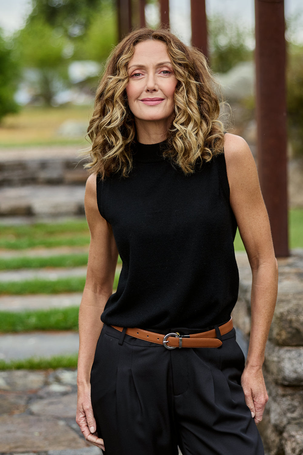 Model Emma wearing size S of The Soft Sleeveless Mockturtle Jumper in colour Black (Black), from the front, showing the whole outfit