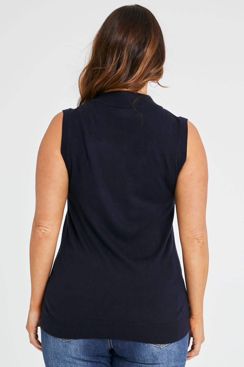 Model Laura wearing size L of The Soft Sleeveless Mockturtle Jumper in colour Darknavy (Blue), from the back