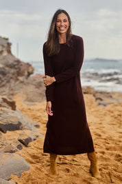 Model Madeline wearing size S of The Keepers Soft Knit Maxi Dress in colour Plum (Purple), from the front, showing the whole outfit