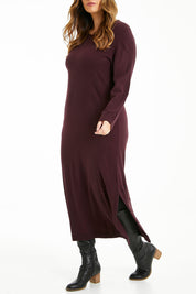 Model Laura wearing size L of The Keepers Soft Knit Maxi Dress in colour Woodberry (Purple), from the front, cropped image