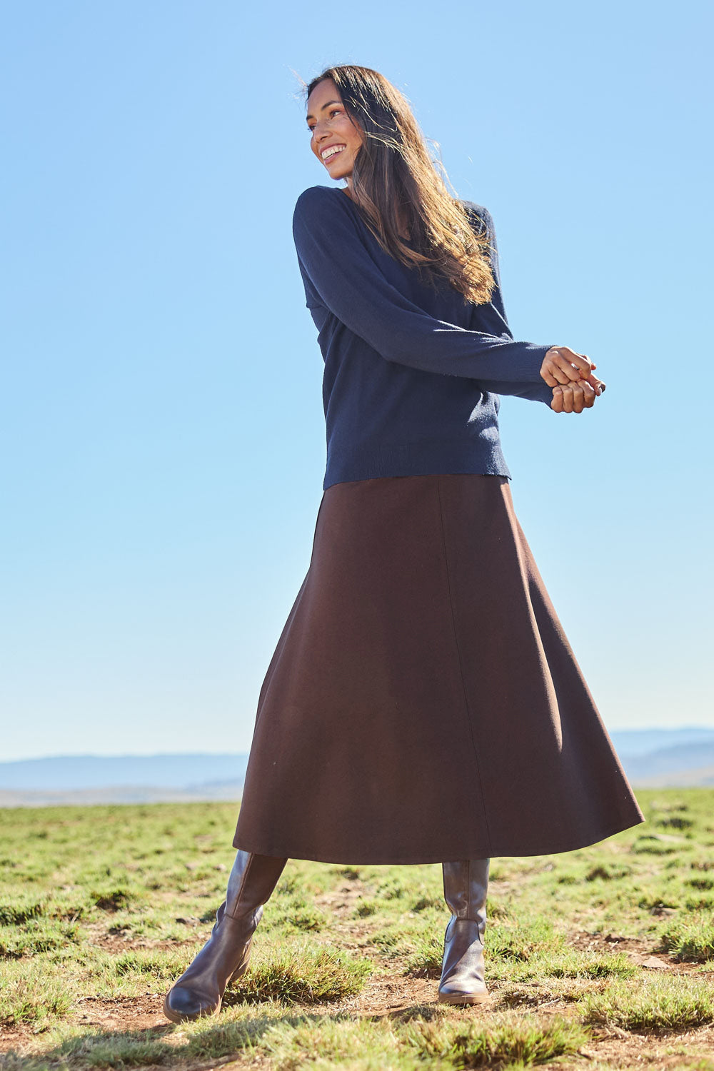 Model Amanda wearing size 10 of The Fit And Flare Ponte Skirt in colour Chocolate, from the front, showing the whole outfit