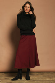 Model Madeline wearing size 10 of The Fit And Flare Ponte Skirt in colour Cognac (Red), from the front, showing the whole outfit
