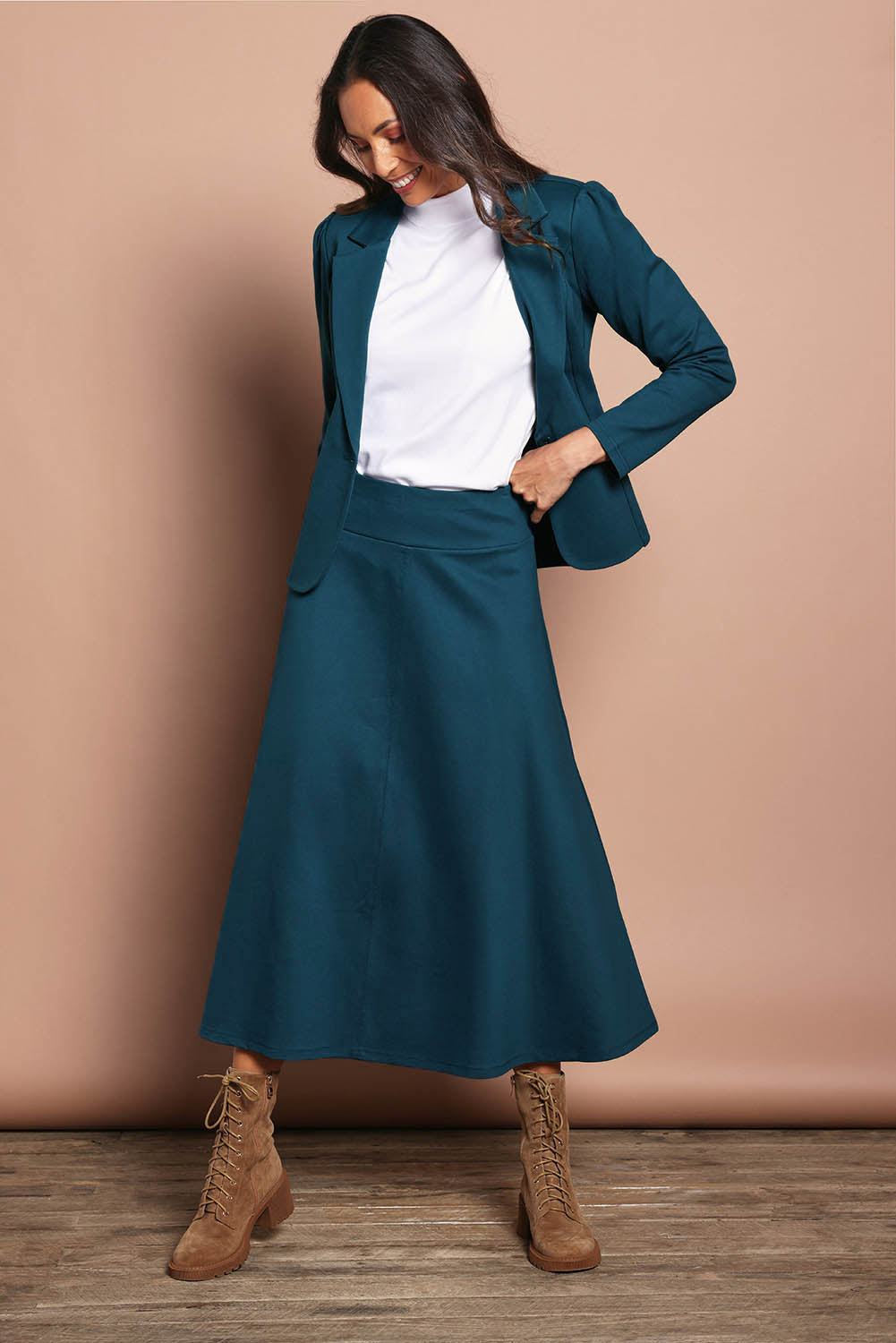 Model Amanda wearing size 10 of The Fit And Flare Ponte Skirt in colour Teal (Blue), from the front, showing the whole outfit