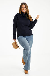 Model Laura wearing size L of The Keepers Soft Roll Neck Jumper in colour Darknavy (Blue), from the front, showing the whole outfit