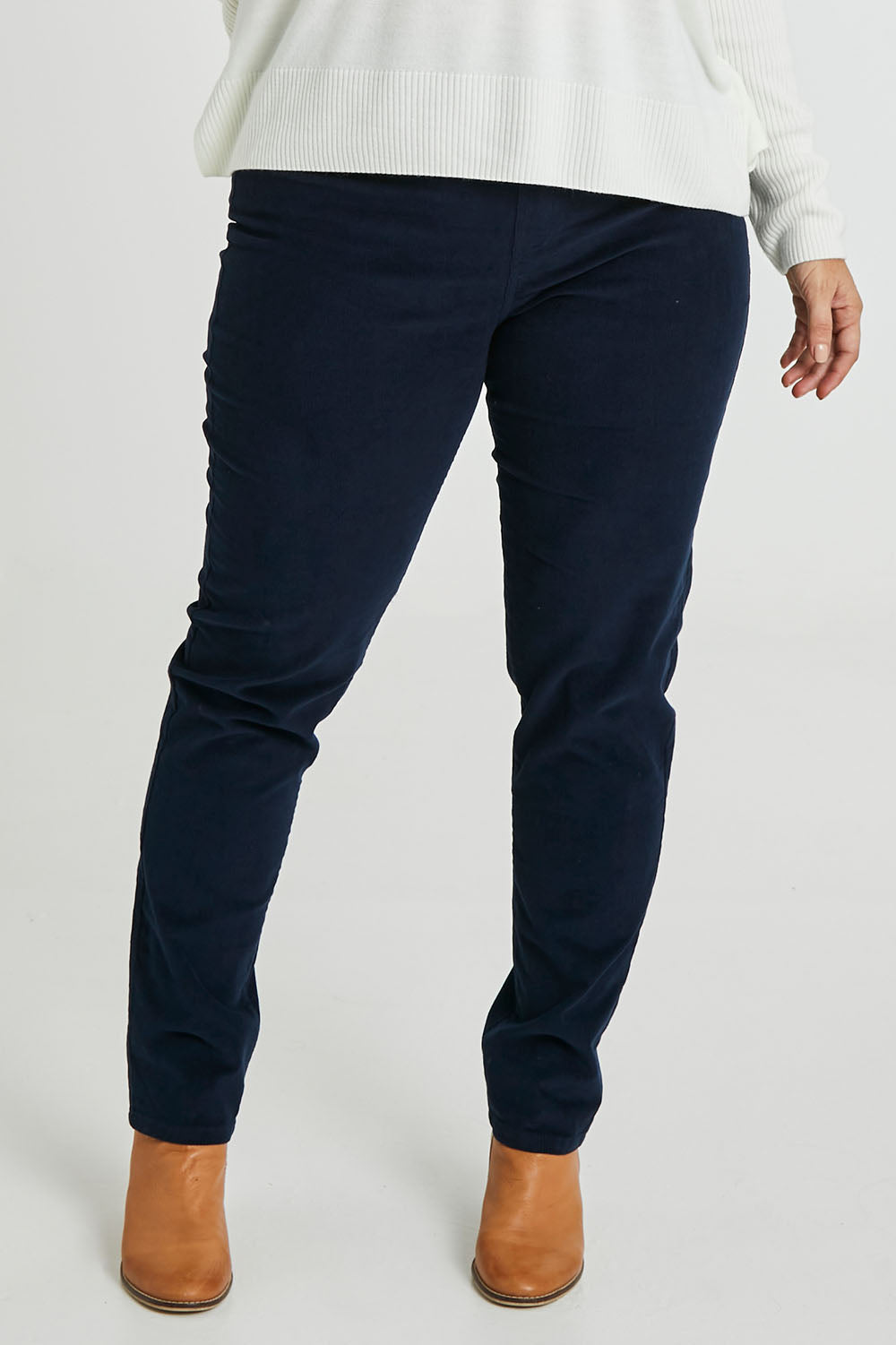 Model Laura wearing size 14 of The Pull On Cord Pant in colour Navy (Blue), from the front, cropped image