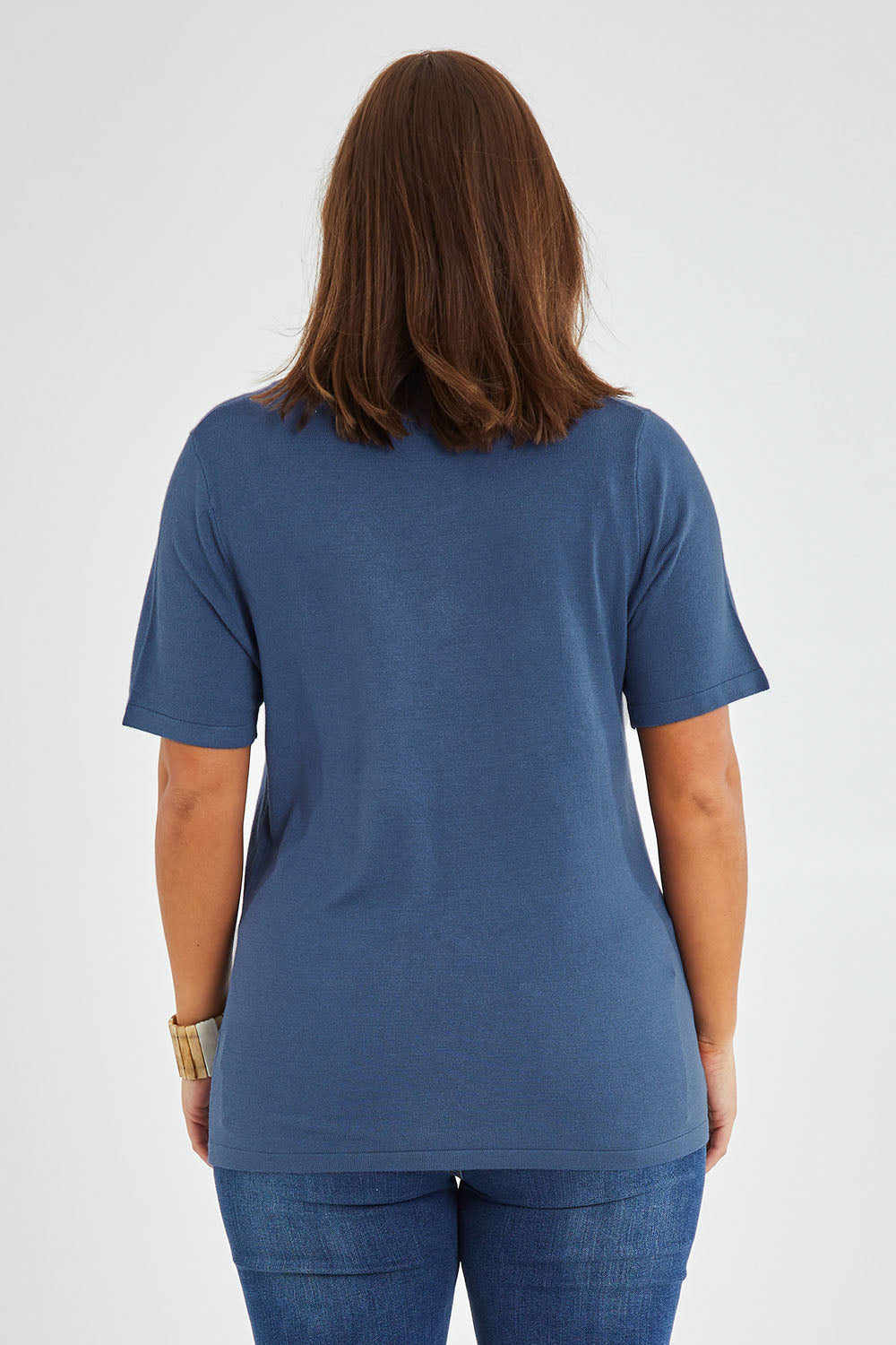 Model Monique wearing size L of The Transeasonal Short Sleeve Jumper in colour Blueberry (Blue), from the back