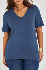 Model Monique wearing size L of The Transeasonal Short Sleeve Jumper in colour Blueberry (Blue), from the front, cropped image