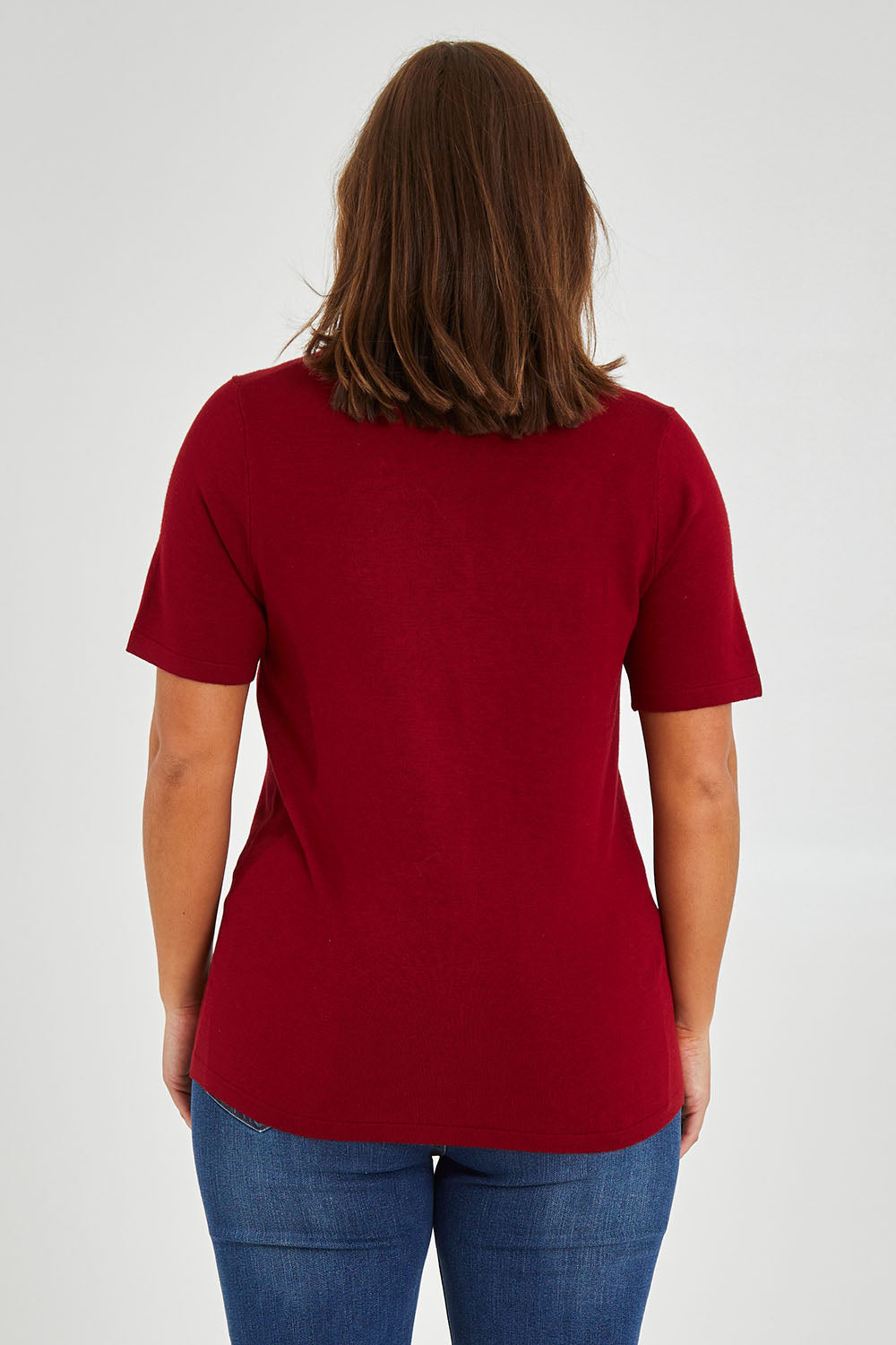 Model Monique wearing size L of The Transeasonal Short Sleeve Jumper in colour Raspberry (Red), from the back