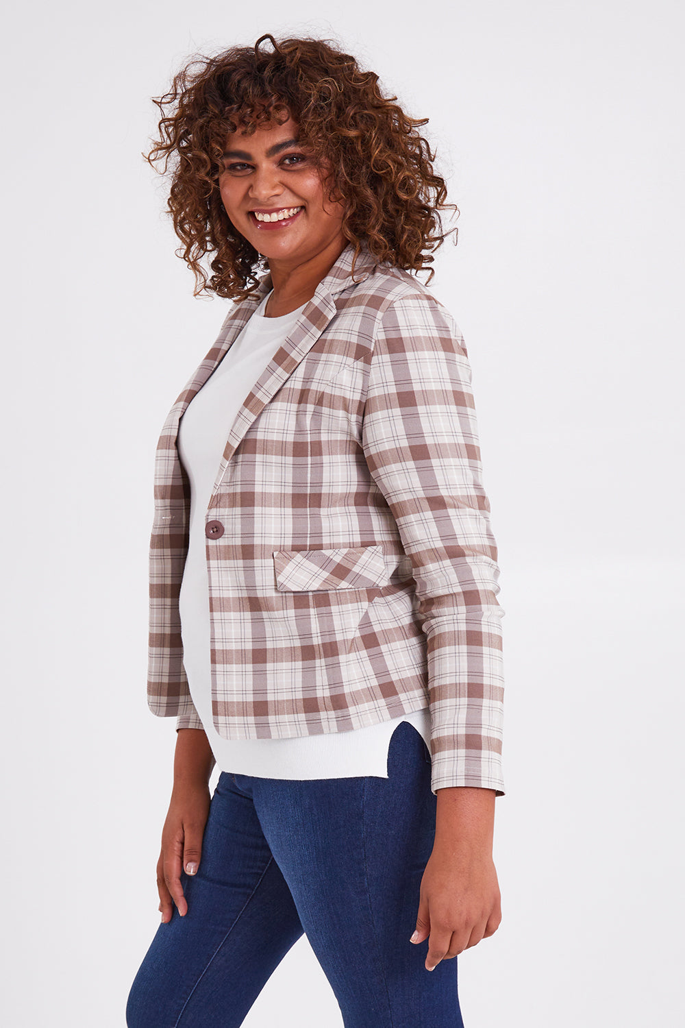 Model Anucia wearing size 14 of The Classic Check Blazer in colour Fawncheck, from the front, cropped image