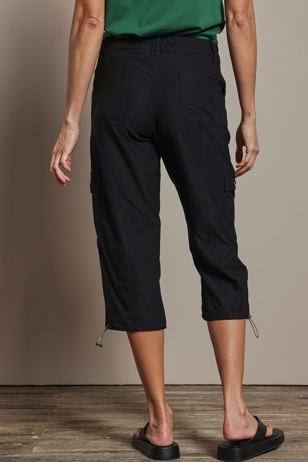 Model Amanda wearing size 10 of The Everyday Cropped Cargo Pant in colour Black (Black), from the back