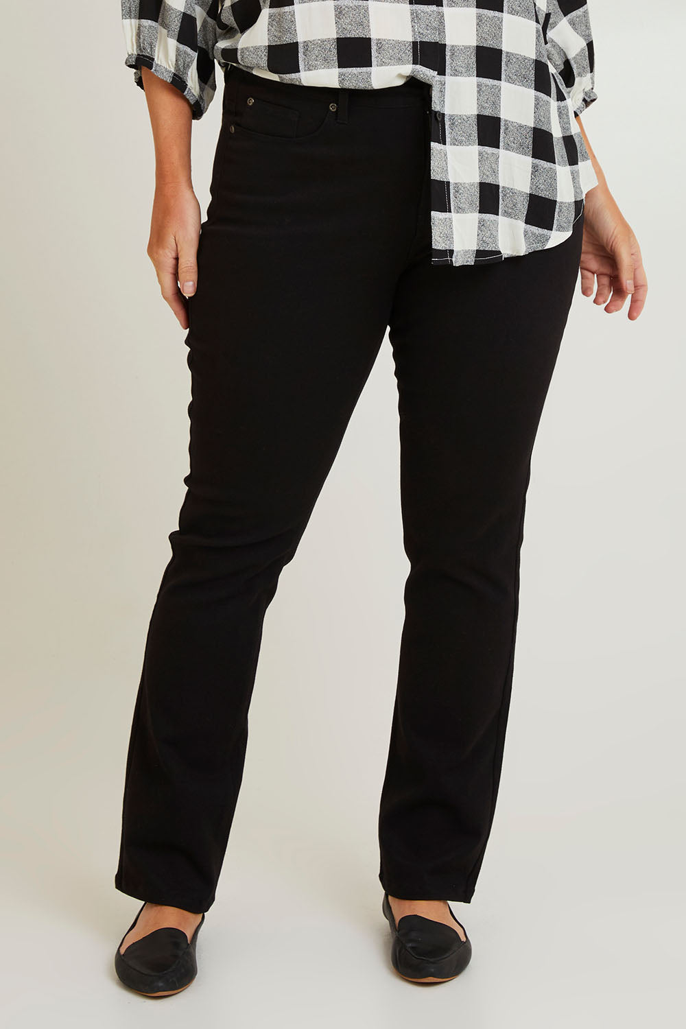 Model Laura wearing size 14 of The Stretch Coloured Denim Jean in colour Black (Black), from the front, cropped image