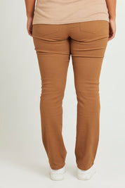 Model Monique wearing size 14 of The Stretch Coloured Denim Jean in colour Caramel, from the back