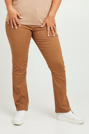 Model Monique wearing size 14 of The Stretch Coloured Denim Jean in colour Caramel, from the front, cropped image