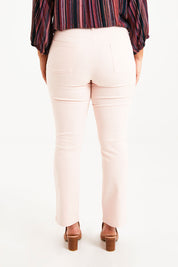 Model Monique wearing size 14 of The Stretch Coloured Denim Jean in colour Fairyfloss (Pink), from the back