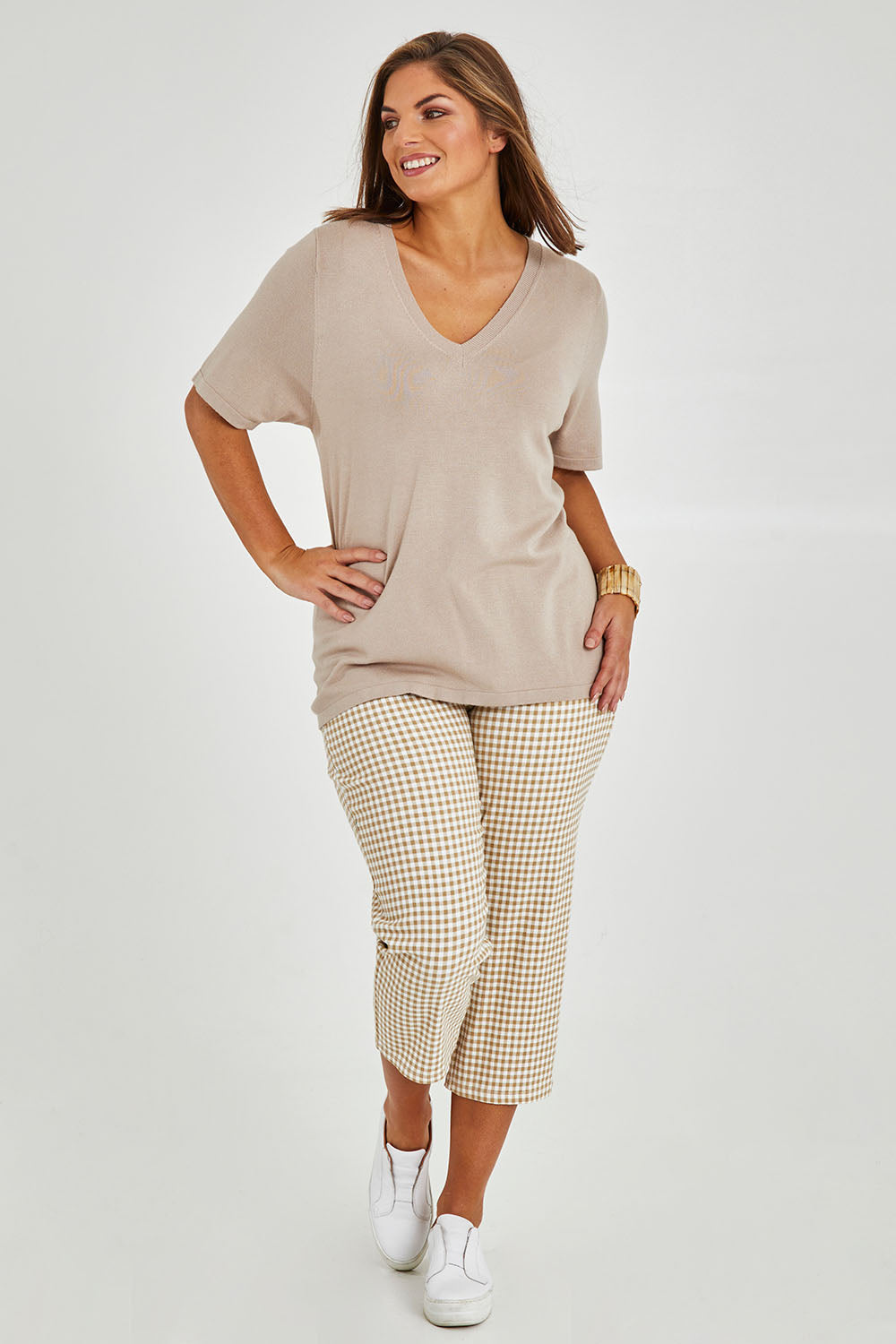 Model Monique wearing size 14 of The Check Pull On Pant in colour Taupewhite, from the front, showing the whole outfit