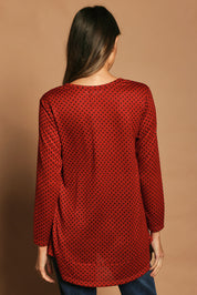 Model Madeline wearing size 10 of The Spot Swing Knit Tee in colour Burntred (Red), from the back