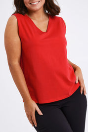 Model Monique wearing size 14 of The Keepers Cotton Tank in colour Red (Red), from the front, cropped image