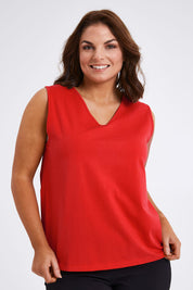 Model Monique wearing size 14 of The Keepers Cotton Tank in colour Red (Red), from the front, cropped image