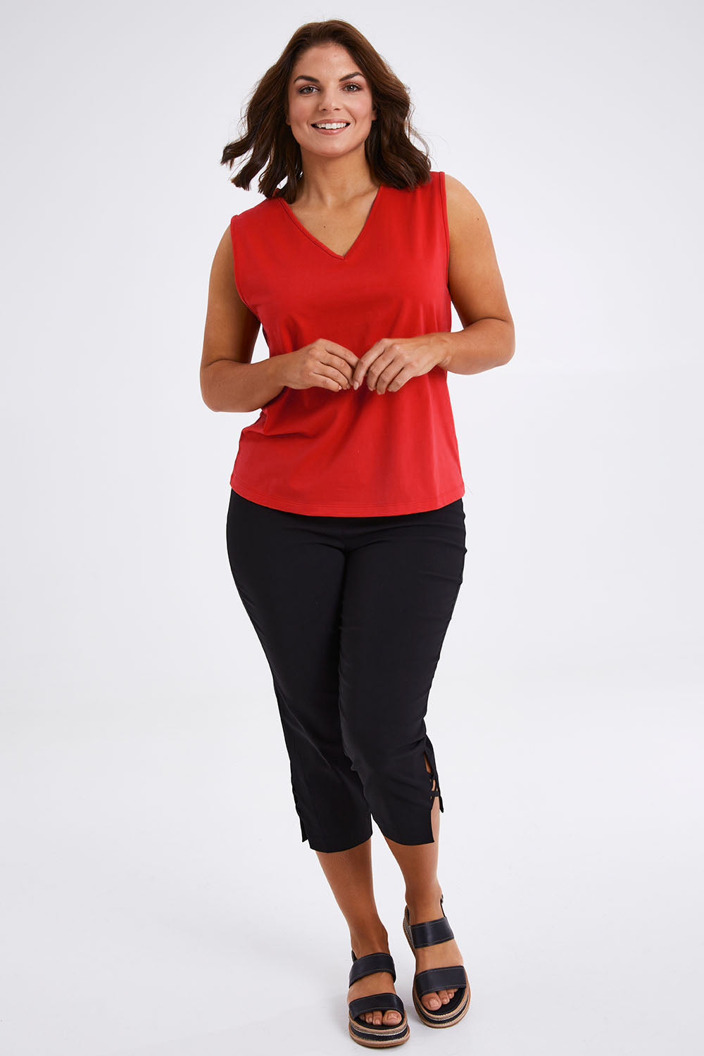Model Monique wearing size 14 of The Keepers Cotton Tank in colour Red (Red), from the front, showing the whole outfit