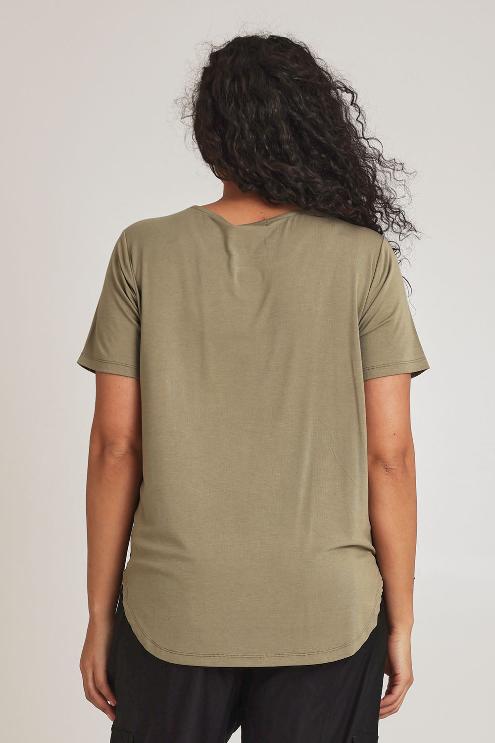 Model Terri-Leigh wearing size 14 of The Bamboo Curved Hem Tee in colour Khaki (Green), from the back
