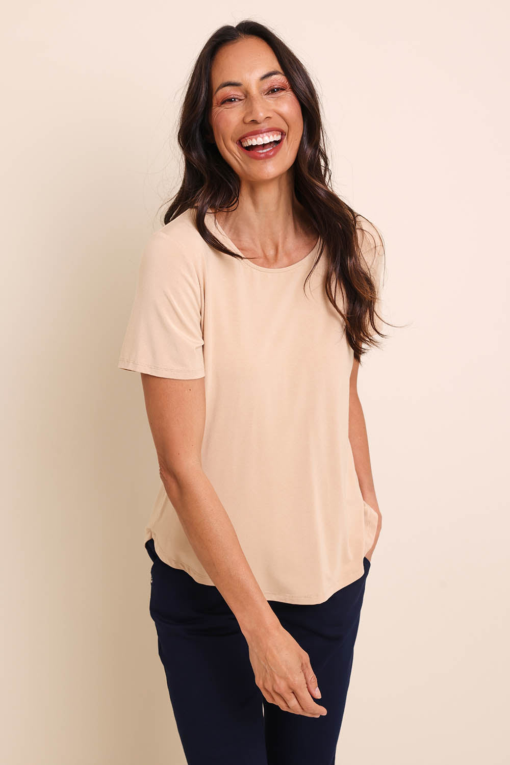 Model Amandam wearing size 10 of the The Bamboo Curved Hem Tee – Almond in colour Almond, in a cropped view