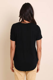 Model Amandam wearing size 10 of the The Bamboo Curved Hem Tee – Black in colour Black, from the back