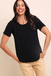 Model Amandam wearing size 10 of the The Bamboo Curved Hem Tee – Black in colour Black, in a cropped view