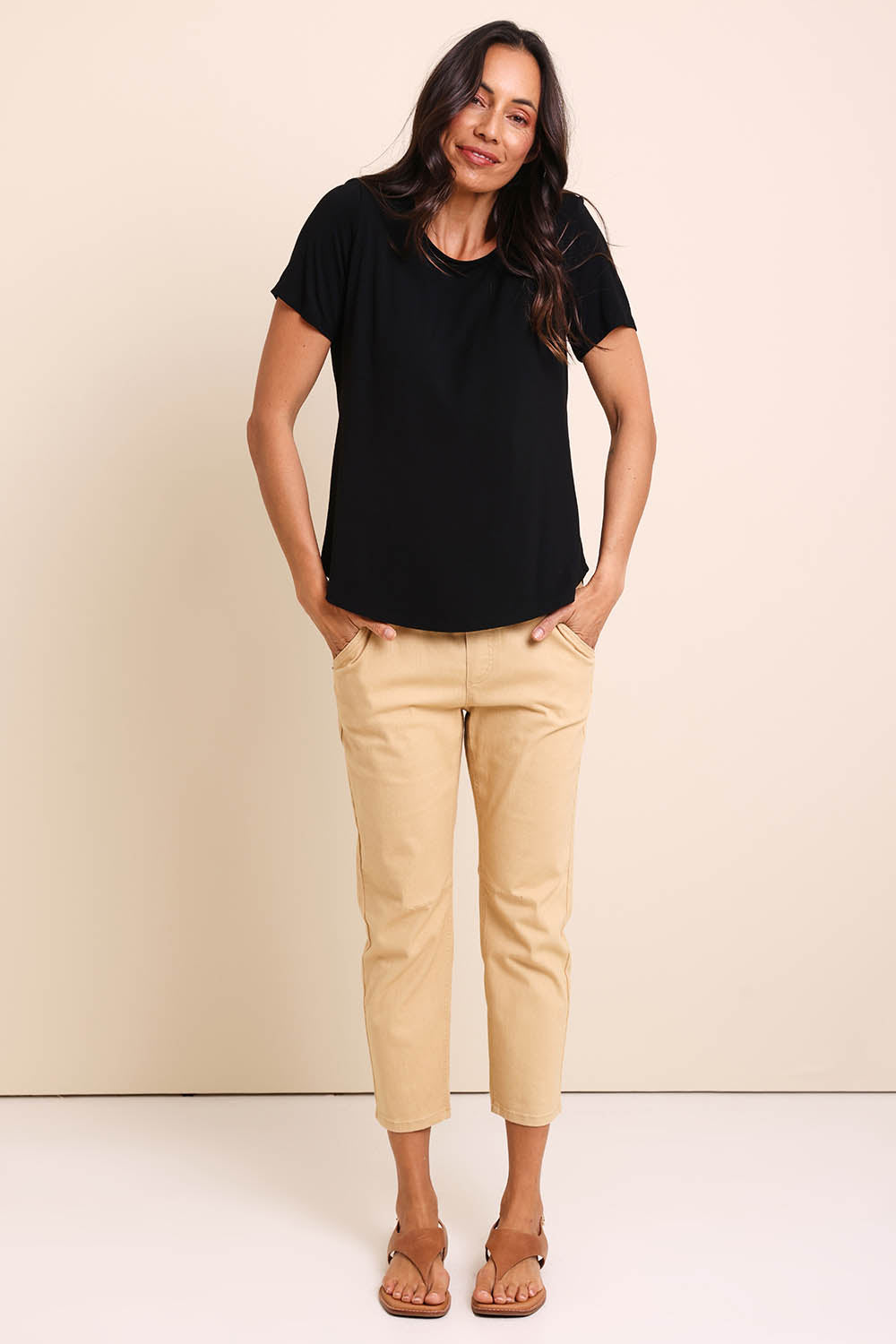 Model Amandam wearing size 10 of the The Bamboo Curved Hem Tee – Black in colour Black, from the front