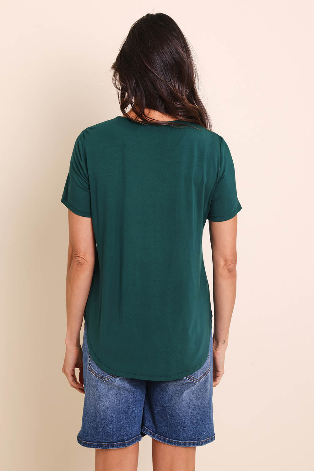 Model Amandam wearing size 10 of the The Bamboo Curved Hem Tee – Forest in colour Forest, from the back
