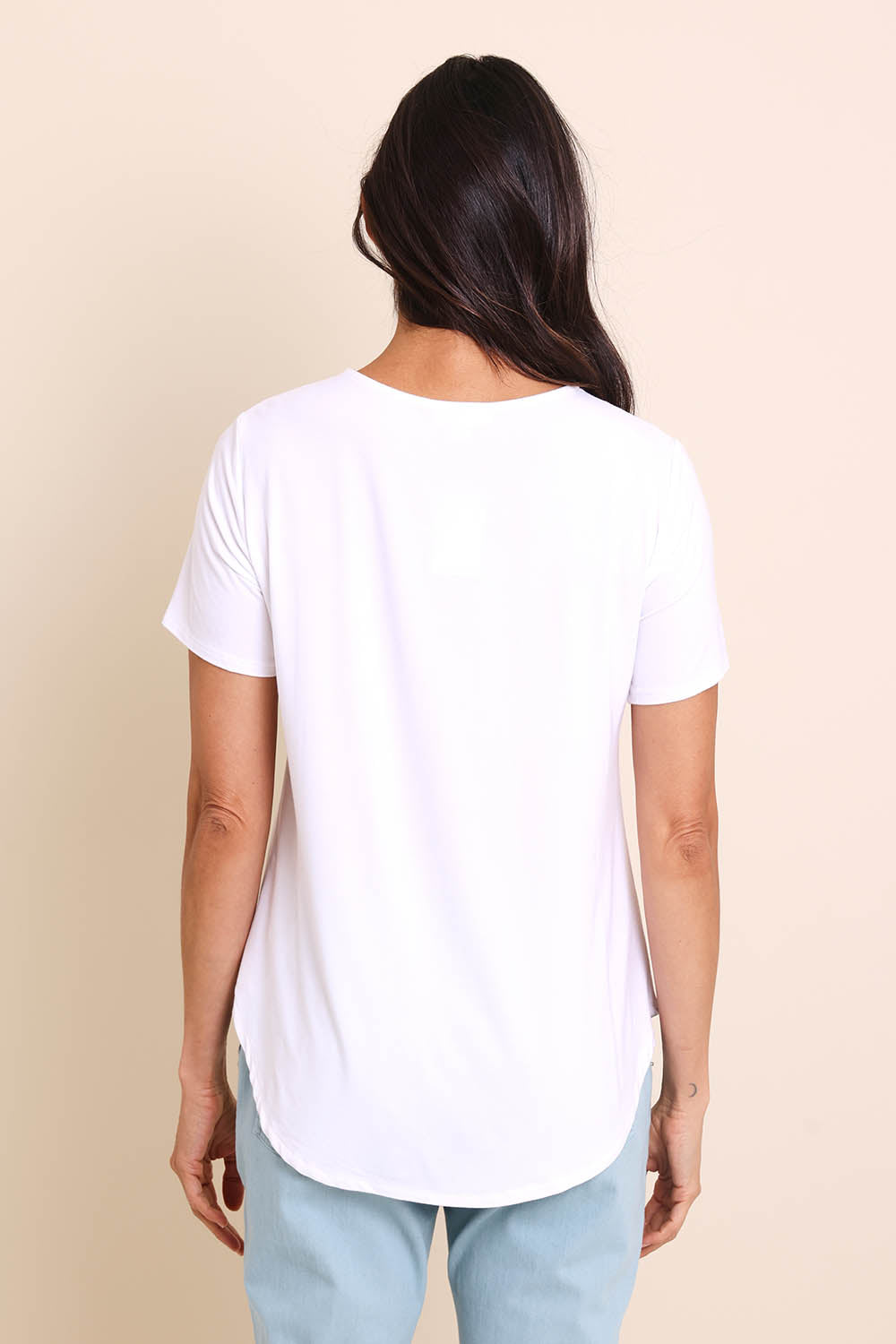 Model Amandam wearing size 10 of the The Bamboo Curved Hem Tee – White in colour White, from the back