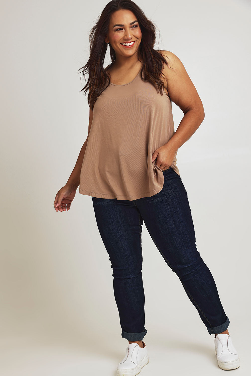 Model Ashleigh wearing size 16 of The Bamboo Crew Neck Swing Tank in colour Caramel, from the front, showing the whole outfit