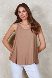 Model Madeline wearing size 10 of The Bamboo Crew Neck Swing Tank in colour Caramel, from the front, showing the whole outfit