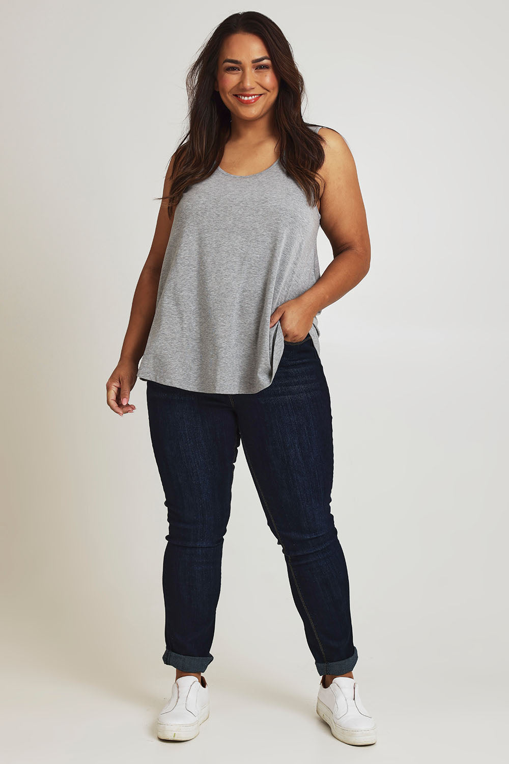 Model Ashleigh wearing size 16 of The Bamboo Crew Neck Swing Tank in colour Greymarle (Grey), from the front, showing the whole outfit