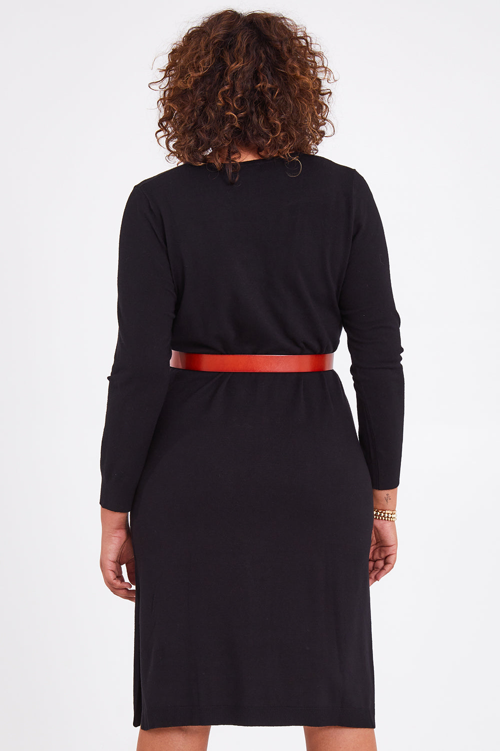 Model Anucia wearing size L of The Transeasonal Knit Dress in colour Black (Black), from the back