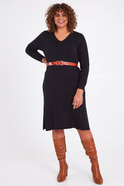Model Anucia wearing size L of The Transeasonal Knit Dress in colour Black (Black), from the front, showing the whole outfit